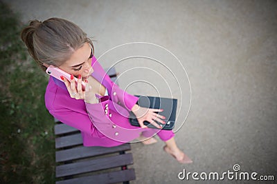 Business woman sitting on a bench in the street Stock Photo