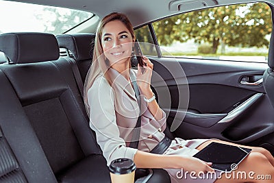 Business woman taxi car cabin, summer day city, happy phoning. greets passengers, emotions of pleasure unexpected Stock Photo