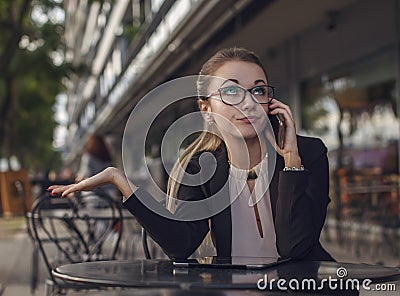 Business woman or teacher talking on the cellphone emotionally Stock Photo