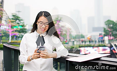 Business woman texting in modern environment Stock Photo