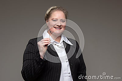 Business woman in thick glasses with coffee, documents and notepads and leather wallet in hand Stock Photo