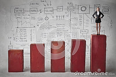 Business woman on the top of the graphic Stock Photo