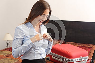 Business woman traveler undressing in a hotel room Stock Photo