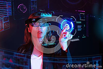 Business woman try vr glasses hololens in the dark room | Portrait of young asian girl experience ar | Future technology concept Stock Photo