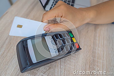 Business woman using her credit card to made a payment with EDC machine Stock Photo
