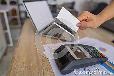 Business woman using her credit card to made a payment with EDC machine Stock Photo