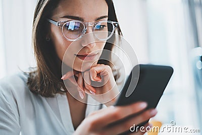 Business woman using mobile phone at working day in office.Blurred background. Business Technology Communications Stock Photo