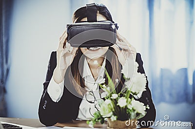 Business Woman using a VR headset for work with virtual reality, with fun and happy new experience, Concept of modern technologies Stock Photo