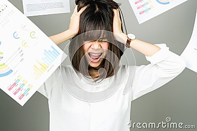 Business woman in a white dress is throw away a lot of paperwork and the documents are blown overhead. Stock Photo