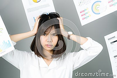 Business woman in a white dress is throw away a lot of paperwork and the documents are blown overhead. Stock Photo