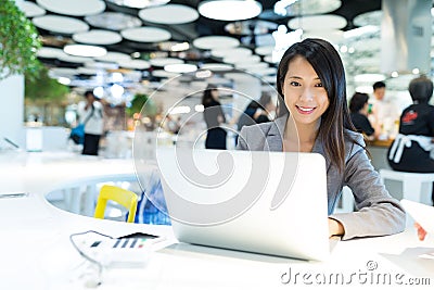 Business woman working on laptop computer in co-working place Stock Photo