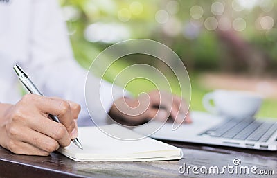 Business woman write on notebook outdoor in coffee shop. Stock Photo