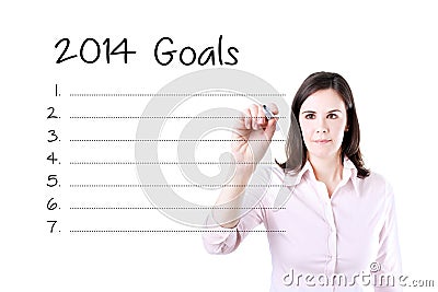 Business woman writing blank 2014 goals list. Stock Photo