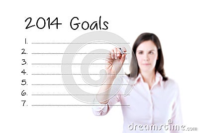 Business woman writing blank 2014 goals list. Isolated on white. Stock Photo