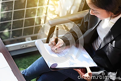 Business woman writing on clipboard outside on terrace,on top view. Stock Photo