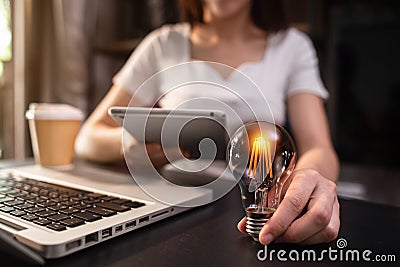 Business women entrepreneurs show creative business strategies with light bulbs as a concept. Stock Photo