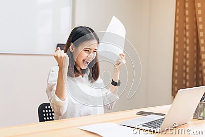 Business women fists being excited of success expressed joy because they work to achieve her goals. Stock Photo