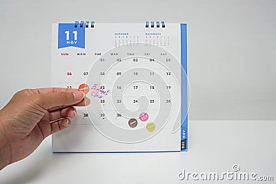 Business women plan meeting on budget on November calendar Stock Photo