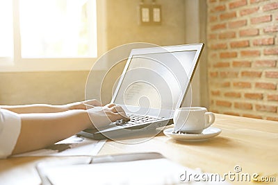 Business women using laptop for analytic financial graph trend forecasting planning at coffee cafe sunlight from window Stock Photo