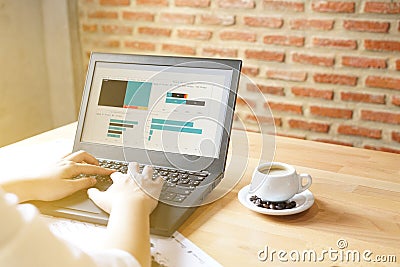 Business women using laptop for analytic financial graph trend forecasting planning at coffee cafe sunlight from window Stock Photo