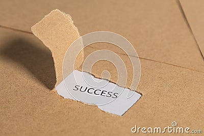 The business word Success written on vintage paper. Top view. Torn paper revealing the word. Innovation and ideas Stock Photo