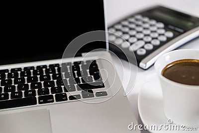 Business work place with cup of coffee calculator and Computer laptop Stock Photo
