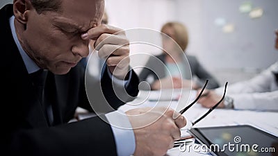 Business worker feeling bad headache at meeting, work frustration and stress Stock Photo