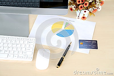 Business workplace concept. Credit card on work desk with computer keyboard and papers graphs Stock Photo