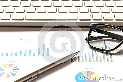Business workplace with keyboard mouse and crumpled paper balls ,papers with graphs and diagrams Stock Photo