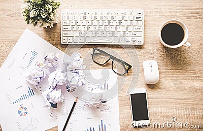 Business workplace with keyboard mouse and crumpled paper balls ,papers with graphs and diagrams . Stock Photo