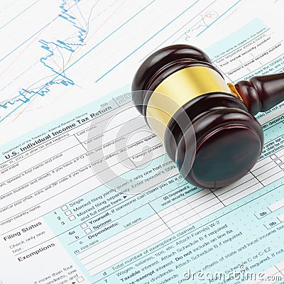 Business world and its symbols - wooden judge`s gavel over 1040 USA Tax Form Editorial Stock Photo