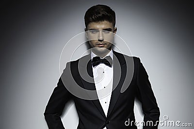 Business young attractive guy in tuxedo standing Stock Photo