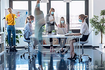 Business young women wearing a hygienic face mask while working in the office. Multiple exposure Stock Photo