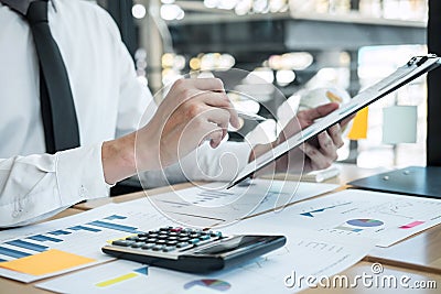 Businessman accountant working analyzing and calculating expense financial annual financial report balance sheet statement, doing Stock Photo