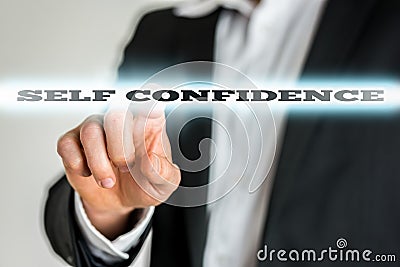 Businessman activating a Self confidence button on virtual scree Stock Photo