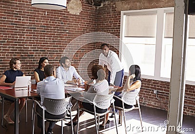 Businessman Addressing Boardroom Meeting Stock Photo