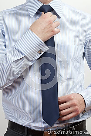 Businessman adjusting tie Stock Photo