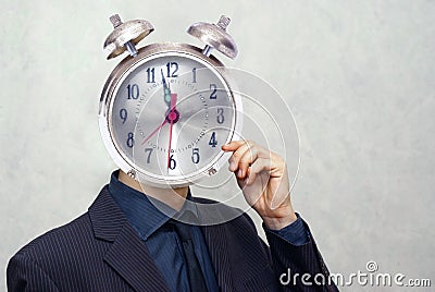 Businessman with alarm clock head Stock Photo