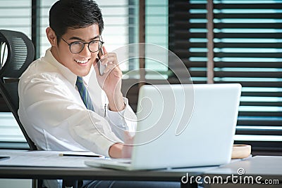 Businessman analyzing investment charts with Smartphones Stock Photo