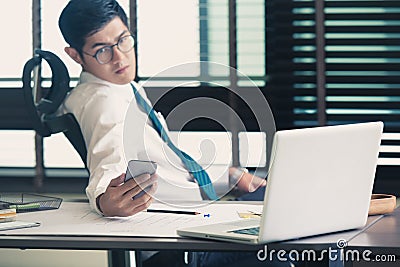 Businessman analyzing investment charts with Smartphones Stock Photo