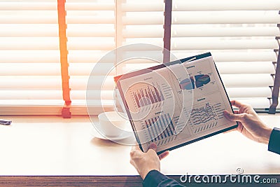 Businessman analyzing investment charts in the work space. Stock Photo