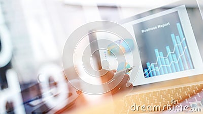 Businessman analyzing sales data and pointing at business graph chart growth and progress on laptop screen. Digital marketing. Stock Photo