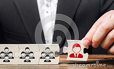 A businessman appoints a leader to the head of the team. Creation of an effective teams of specialists for the implementation Stock Photo