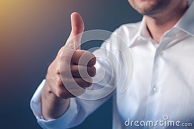 Businessman approving with raised thumb up gesture Stock Photo