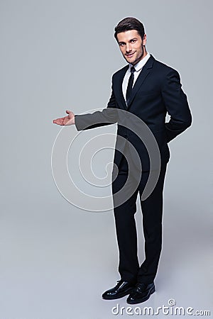 Businessman with arm out in a welcoming gesture Stock Photo