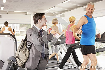 Businessman Arriving At Gym After Work Stock Photo