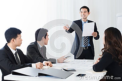 Businessman as a meeting leader asking for an opinion Stock Photo