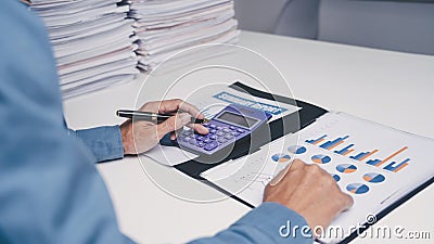 Businessman Asian people individual calculation by calculator income tax form financial paper document at office Stock Photo