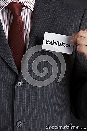 Businessman Attaching Exhibitor Badge To Jacket Stock Photo