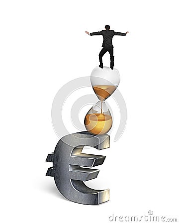 Businessman balancing on hourglass and euro sign Stock Photo